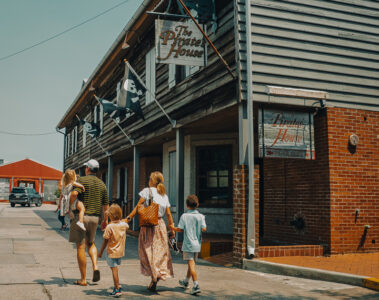 Family of five walking in front of the Pirate's House in Savannah, GA