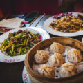 Dumplings, spicy beef and Mongolian beef on table at Etang restaurant in Savannah, Georgia